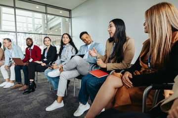 Wall Mural - diverse group in strategy session discussing ideas in modern office setting