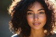 © Mariya - Portrait of Mixed Race African American Teen Girl with Curly Hair Smiling in Soft Golden Hour Light