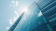 © Mahmud Creative - Blue sky and sun reflected in the windows of a modern office building