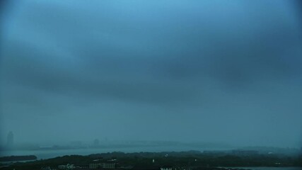 Wall Mural - Time lapse of dark stormy clouds over the seaside city