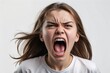 © jejakaryastudio - Close-up portrait of a young woman screaming, expressing anger and frustration.