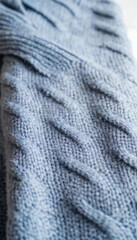 Snowfall-Inspired Sweater: A chunky knit sweater with a color palette of icy blues and whites, featuring patterns that resemble snowflakes scattered across the fabric, with a luxurious wool texture gi