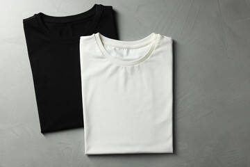 Sticker - Different blank t-shirts on grey background, top view. Mockup for design