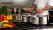 © chusnul - Professional chef preparing colorful vegetable in a modern kitchen with pots on a stove