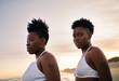 © LIGHTFIELD STUDIOS - Black lesbian woman looking at the sunset on the ocean