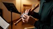 © Tati - Person cleaning wooden flute in music room