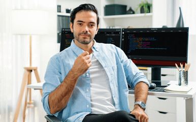 Wall Mural - profile's smart it developer looking camera to pose against on software development coding on two pc