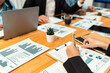 © InfiniteFlow - Diverse group of business analyst team analyzing financial data report paper on office table. Chart and graph dashboard by business intelligence analysis for strategic marketing planning Habiliment