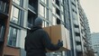 © bussi - Premium High-Rise Delivery: Courier Delivering Package to Concierge Desk of High-Rise Apartment Building, Showcasing Secure and Professional Service for Residential Logistics