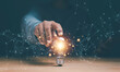 © krungchingpixs - Businessman touching at bright lightbulb on wooden table with global network icon. Motivation and innovation concept. Smart intelligent creativity, Idea and inspiration for global network technology.