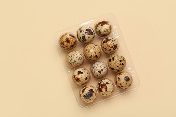 Canvas Print - Plastic holder with fresh quail eggs on beige background