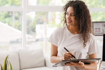 Wall Mural - Female African-American graphic designer with tablet in office