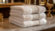© visual artstock - Luxury white bath towels stacked on marble countertop in elegant bathroom