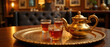 © Yury - Eid al-Adha tea ceremony with steaming glasses on a decorative tray and ornate teapot exuding warmth and hospitality in a cozy, elegantly styled setting
