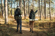 © Dusan - Young caucasian couple boyfriend and girlfriend hiking or trekking through the forest