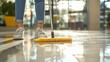© SY - Woman mopping shiny floor with yellow mop. Shows cleaning service, hygiene, and cleanliness.