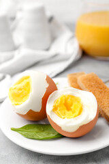 Wall Mural - Soft boiled eggs with bread on grey table, closeup