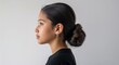 © sevenSkies - Black background Hispanic girl side view portrait on plain white background