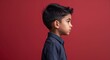 © sevenSkies - Red background Hispanic boy side view portrait on plain white background