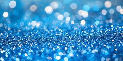 Wall Mural - abstract background with blue glitter lights and bokeh, defocused glowing effect.