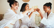 © HockleyM4/peopleimages.com - Women, friends and toast drinks at spa, bed and happy for reunion, bonding and alcohol at resort. People, girl and group with champagne, glass or celebration with cheers in hotel room on holiday