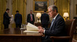 © KingWhite - Serious man reading important documents at oval office desk important government official reviewing paperwork presidential on transparent background