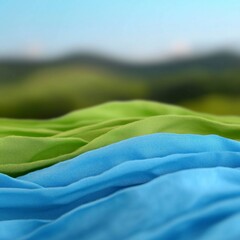 Canvas Print - Blue and Green Fabric Draped Over Landscape Background