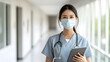 © wrstock - Confident Asian Med Woman Holding a Table in Modern Office Setting