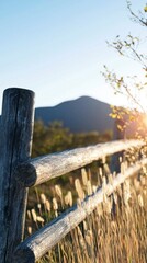 Wall Mural - Rustic Wooden Fence at Sunset with Mountain View