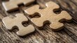 © rawdesign - Wooden Puzzle Pieces on Rustic Table: A Close-Up of Interlocking Jigsaw Parts