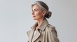 © sevenSkies - Caucasian woman beige trench coat middle age side view portrait on plain white background