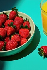 Wall Mural - Fresh strawberries with leaves, in a white bowl. Beverage in the background.