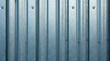 © wichit - Close-up view of a weathered metallic corrugated surface showing subtle texture and tonal variations