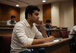 © SRD - Student taking notes in lecture hall, College student listening to professor, Generative AI image