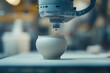 © DOUGLAS - robotic arm crafting handmade ceramic teapot with precision