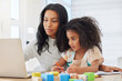 © peopleimages.com - Home, mother and child with laptop for education, support and helping with math for kindergarten. House, woman and girl with digital for elearning platform, problem solving and cognitive development