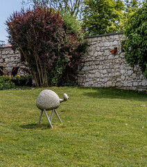 A cute little animal sculpture in a garden