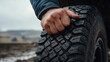 © DreamVision AI & Art - Cool and Masculine Tire Theme, masculine hand gripping heavy duty tire, showcasing strength and determination