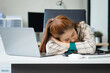 © Phushutter - Asian businesswoman sits at her ergonomic desk, working on a laptop and mobile phone. Her posture ensures minimal strain, addressing neck pain, back pain, and preventing repetitive strain injuries.