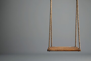 Poster - Simple wooden swing suspended by rope against gray background