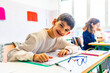 © unai - Happy boy studying in classroom at elementary school