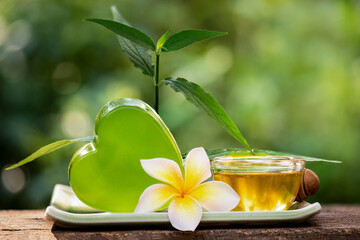 Wall Mural - Glycerin soap mixed with Clinacanthus nutans (Burm.f.) Lindau branch green leaves extract and honey on natural background.