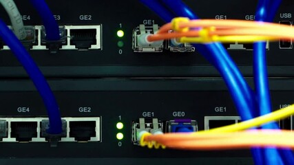 Wall Mural - close up view of internet ethernet cable on network switches background in server room data center