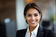 © Nadun - Happy Hispanic Female Entrepreneur Smiling Confidently in a Professional Office Setting