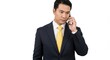 © EZPS - Man in asuit with a yellow tie holding a phone to his ear, isolated on a white background.