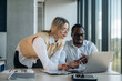 © standret - Having the conversation. Two business people are working together in the office