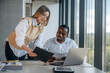 © standret - By the laptop. Two business people are working together in the office