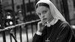 © Mads - A black and white photo of young nun, sitting on the street