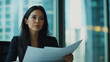 © SB4 GM - A woman office administrator coordinating meetings, preparing agendas, and reviewing reports in a sleek, modern office, with a focus on multitasking