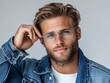 © H Ray - A man in a trendy outfit adjusting his glasses while looking confidently at the camera
